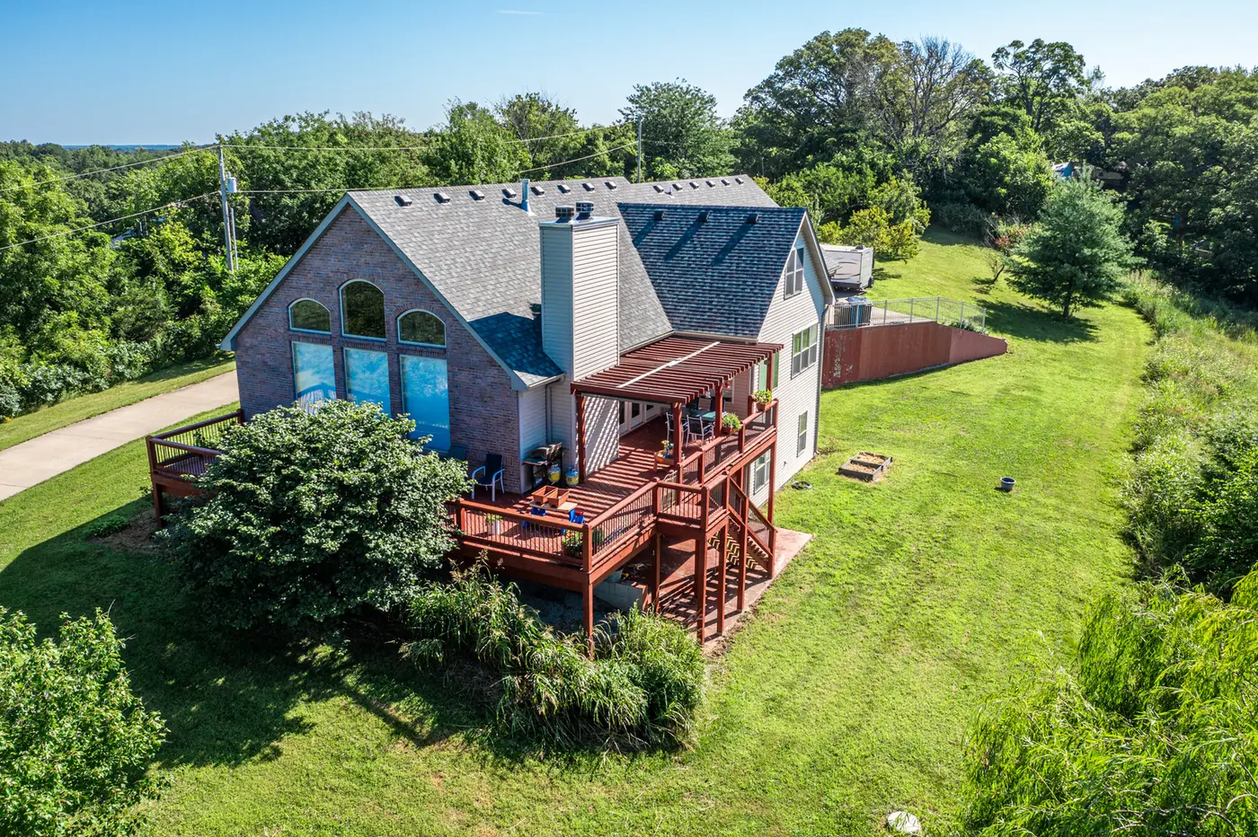 Aerial photograph of a brick home with a large yard